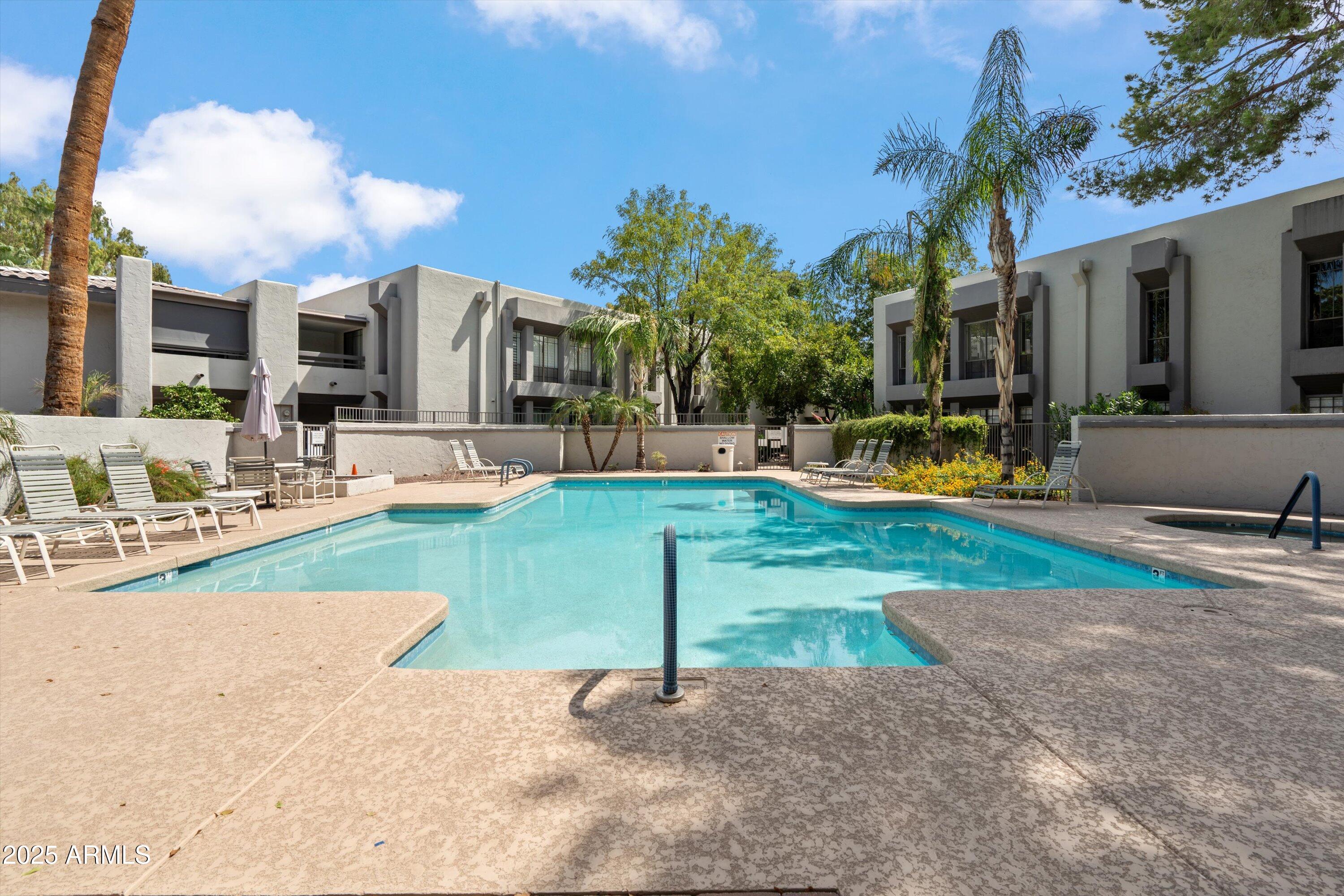 5201 North 24th Street, Unit 206 Phoenix, AZ 85016 - Photo 32 of 39 a view of a house with swimming pool and a yard