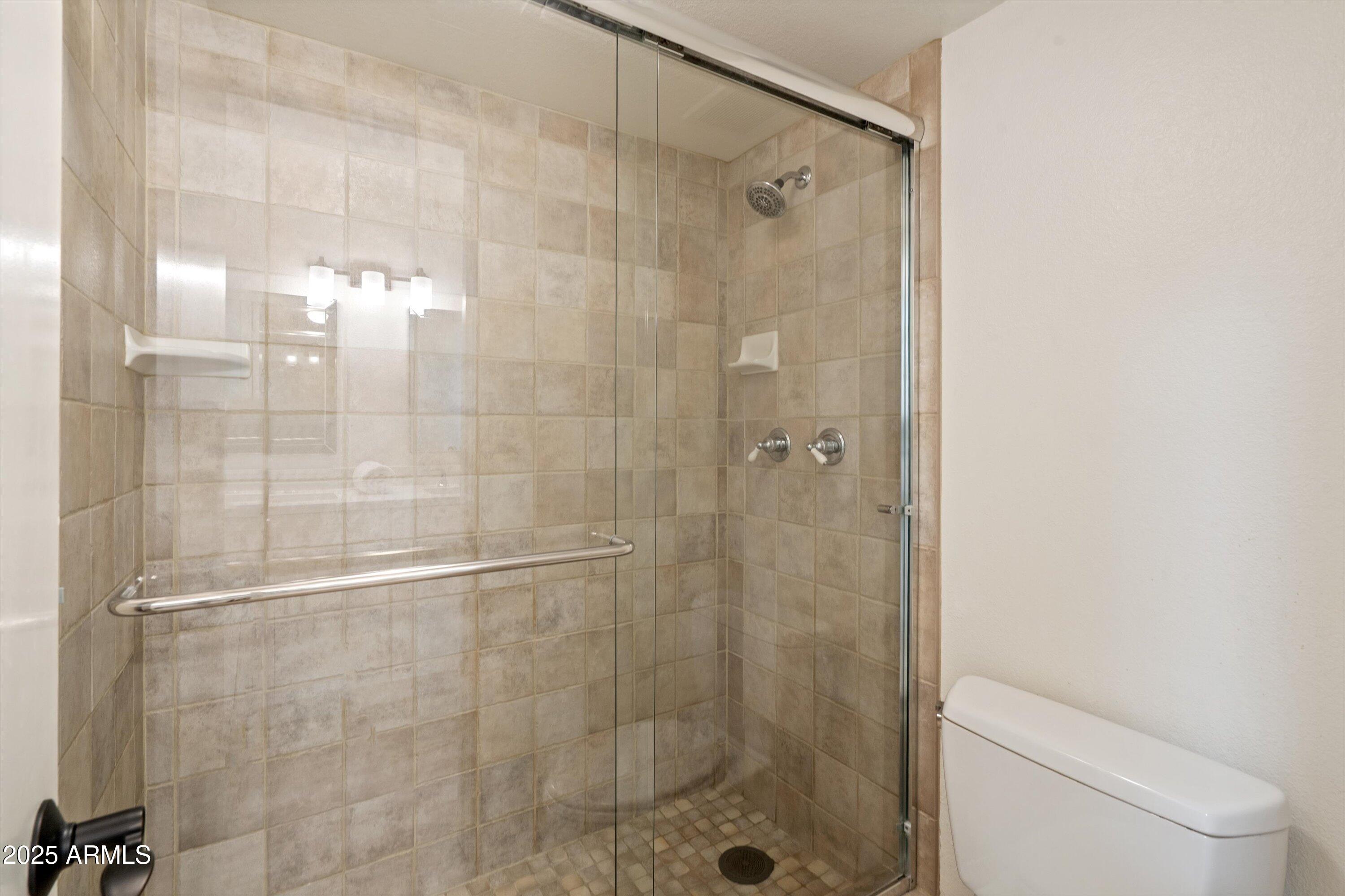 5201 North 24th Street, Unit 206 Phoenix, AZ 85016 - Photo 37 of 39 a bathroom with a shower and a toilet