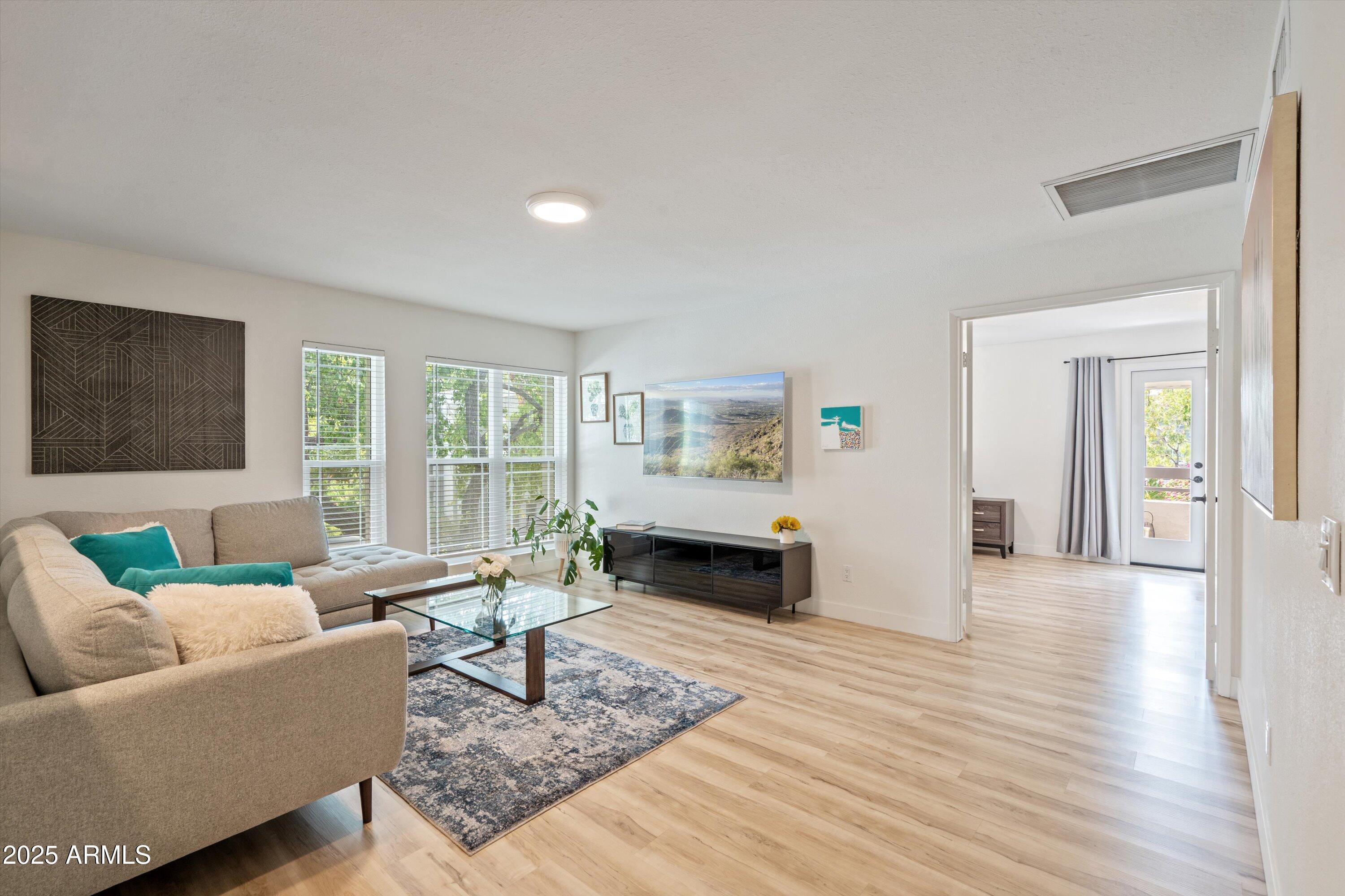 5201 North 24th Street, Unit 206 Phoenix, AZ 85016 - Photo 7 of 39 a living room with furniture and wooden floor
