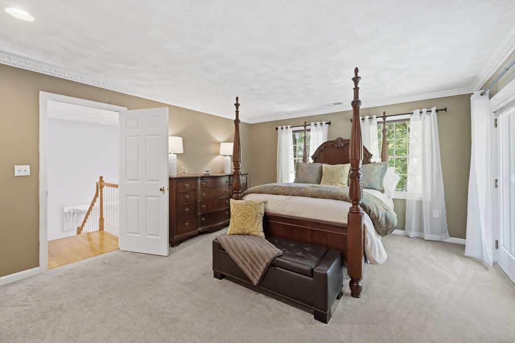 25 Haymeadow Road Boxford, MA 01921 - Photo 23 of 42 a bedroom with a bed closet and a large window