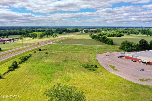 a view of a swimming pool with a yard
