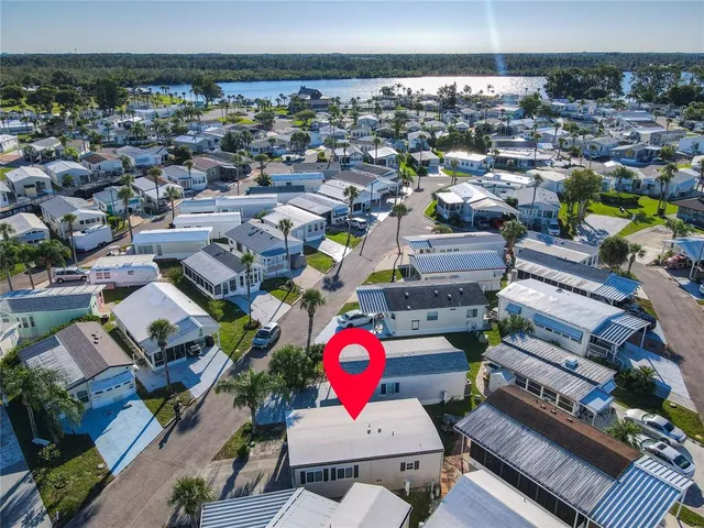 an aerial view of a pool patio chairs and a fire pit