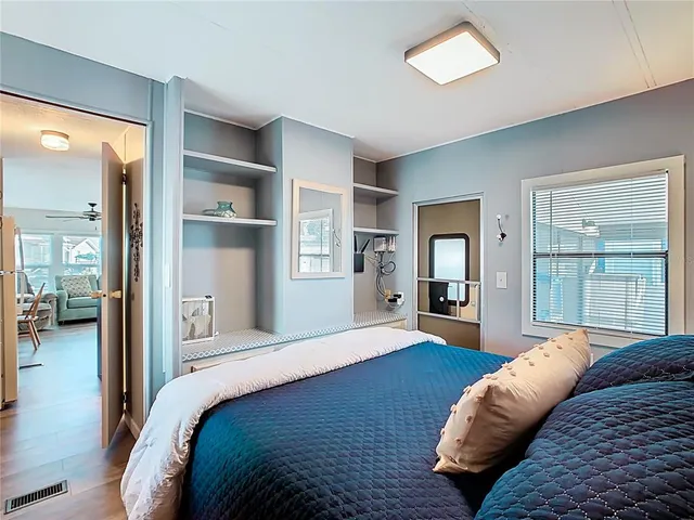 a living room with furniture a flat screen tv and a window