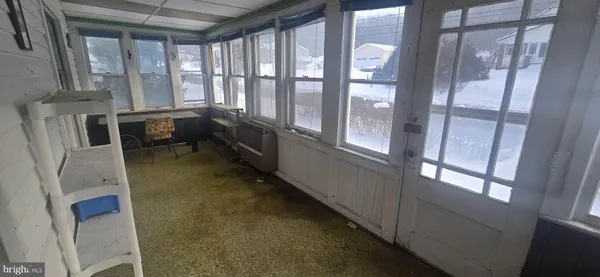 a bathroom with a tub and a large window