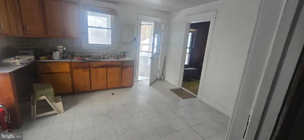 a room with granite countertop cabinets and sink