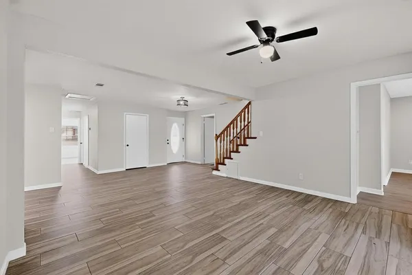 a kitchen with stainless steel appliances granite countertop a sink a microwave a refrigerator and white cabinets