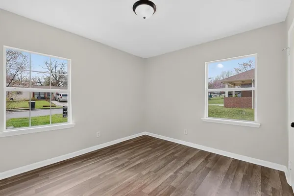 a view of room with wooden floor