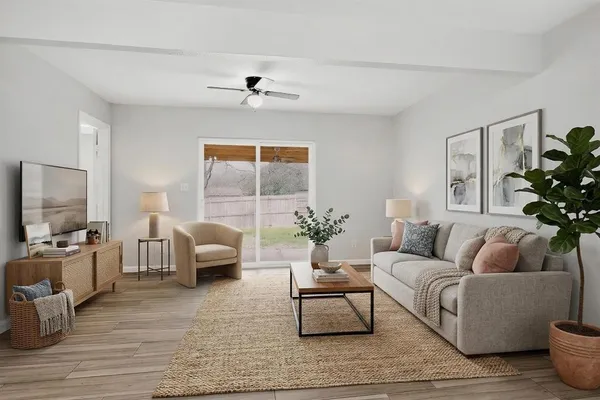 a view of an empty room with wooden floor and stairs