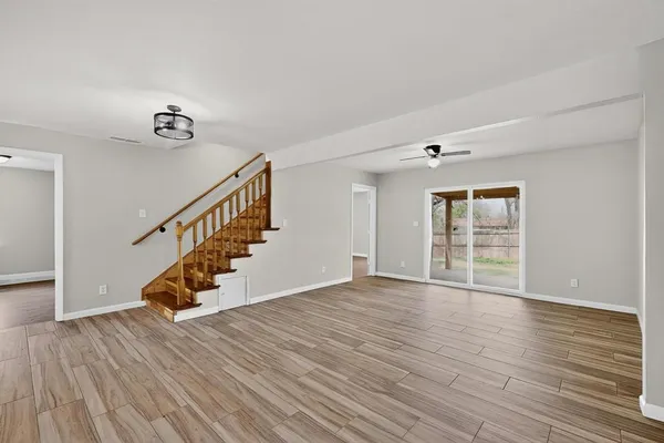 a view of a a dining room with furniture a chandelier and wooden floor