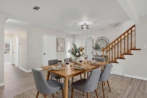 a kitchen with cabinets stainless steel appliances and wooden floor