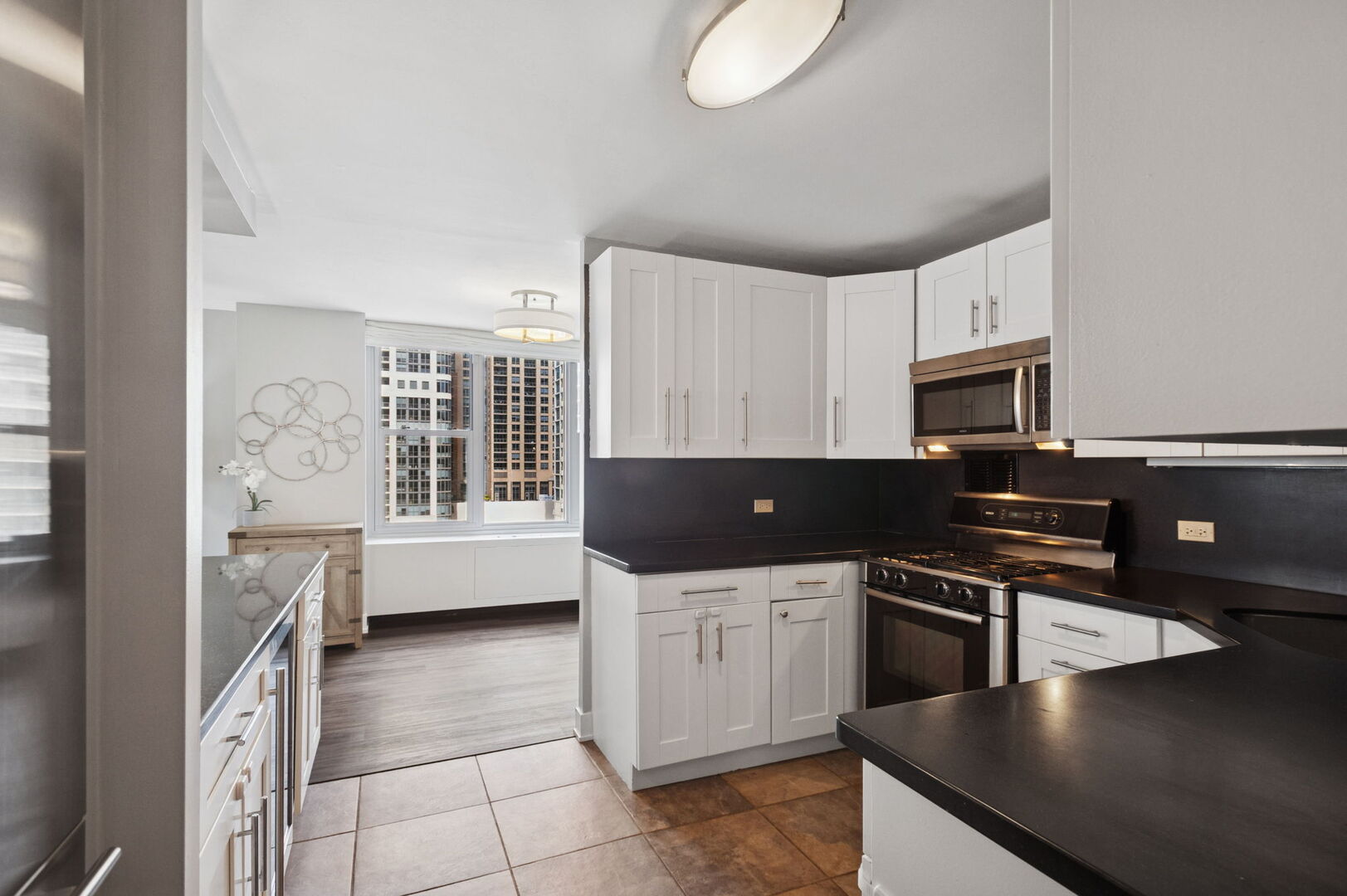 400 East Randolph Street, Unit 930 Chicago, IL 60601 - Photo 5 of 34 a kitchen with stainless steel appliances a stove sink and cabinets