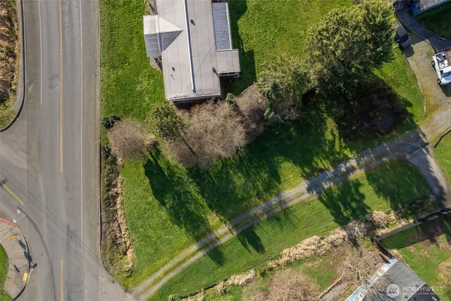 an aerial view of residential house with pool and garden