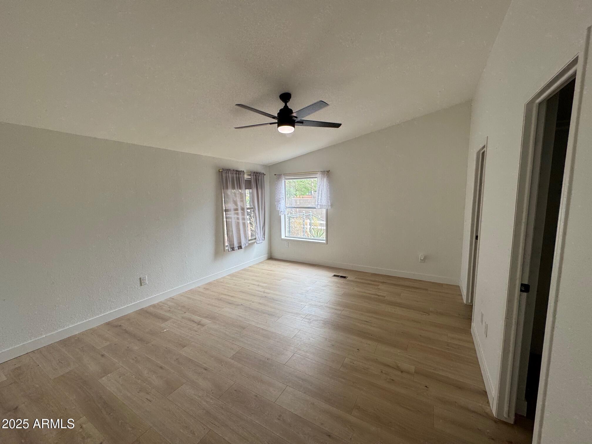1835 East 20th Avenue Apache Junction, AZ 85119 - Photo 19 of 29 an empty room with wooden floor and window