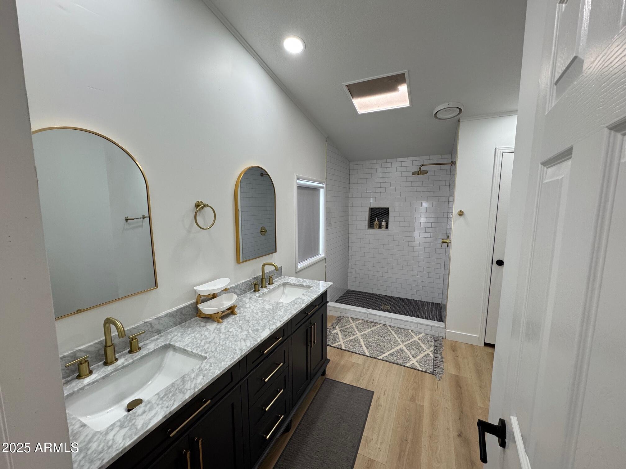1835 East 20th Avenue Apache Junction, AZ 85119 - Photo 21 of 29 a spacious bathroom with a granite countertop double vanity sink a mirror and a shower
