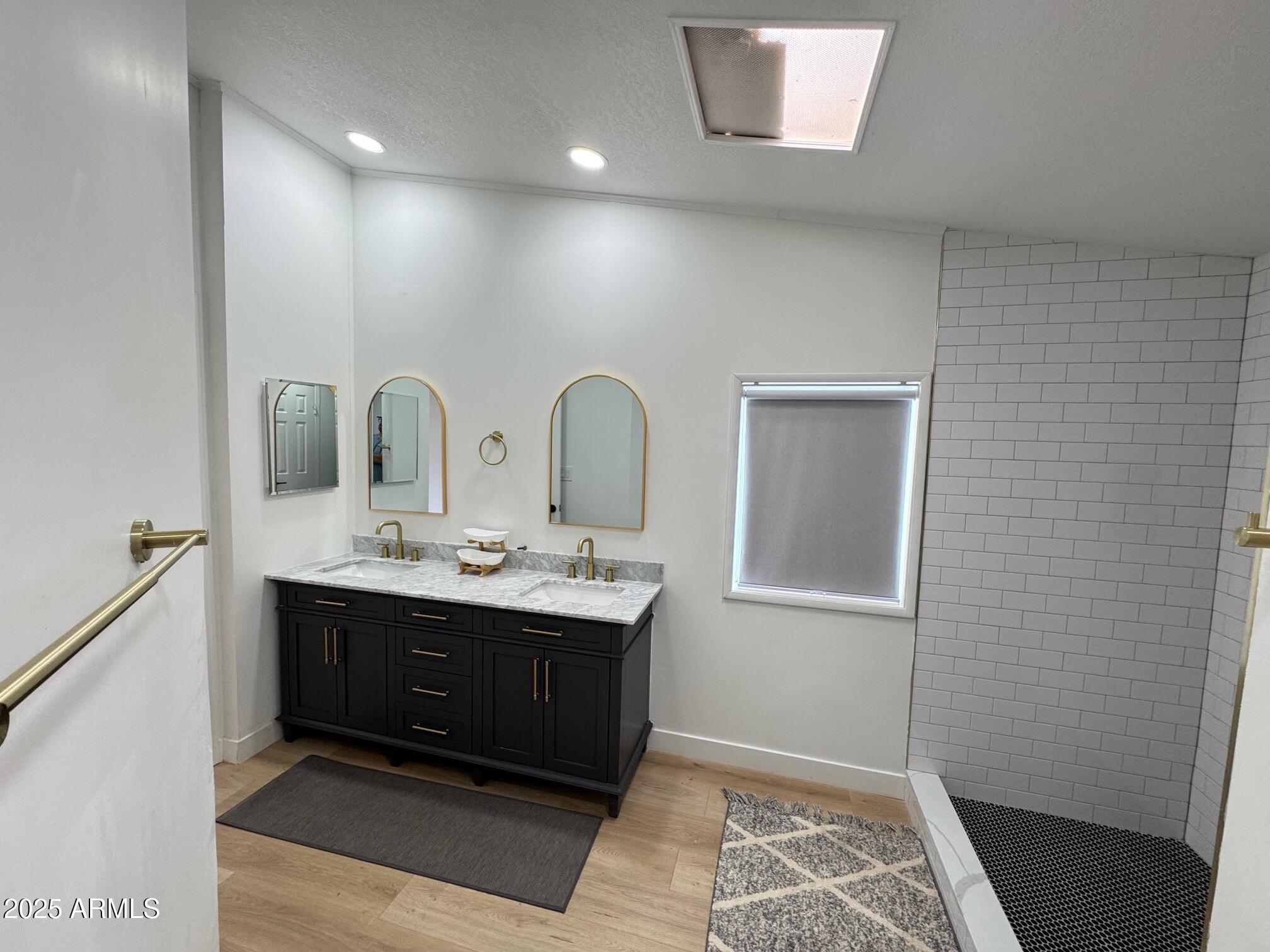 1835 East 20th Avenue Apache Junction, AZ 85119 - Photo 23 of 29 a bathroom with a double vanity sink and a mirror
