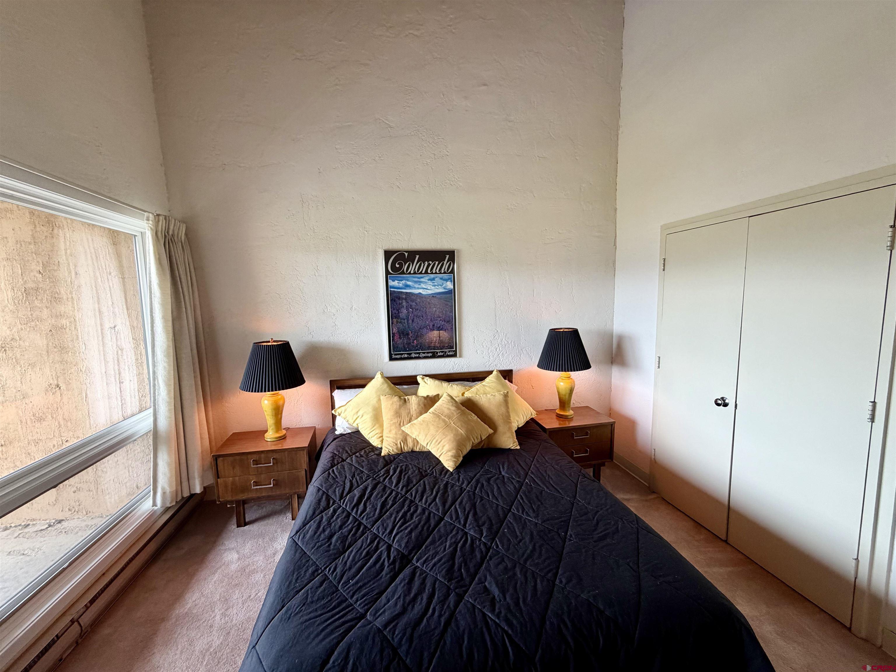 51 Whetstone Road, Unit 2306 Crested Butte, CO 81225 - Photo 24 of 44 a bedroom with bed and a large window