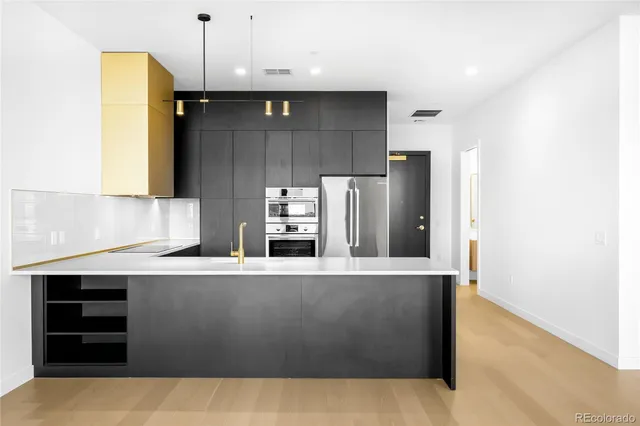 a kitchen with stainless steel appliances a refrigerator and a stove