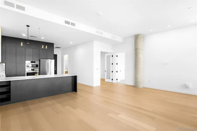 a kitchen with a sink cabinets and stainless steel appliances