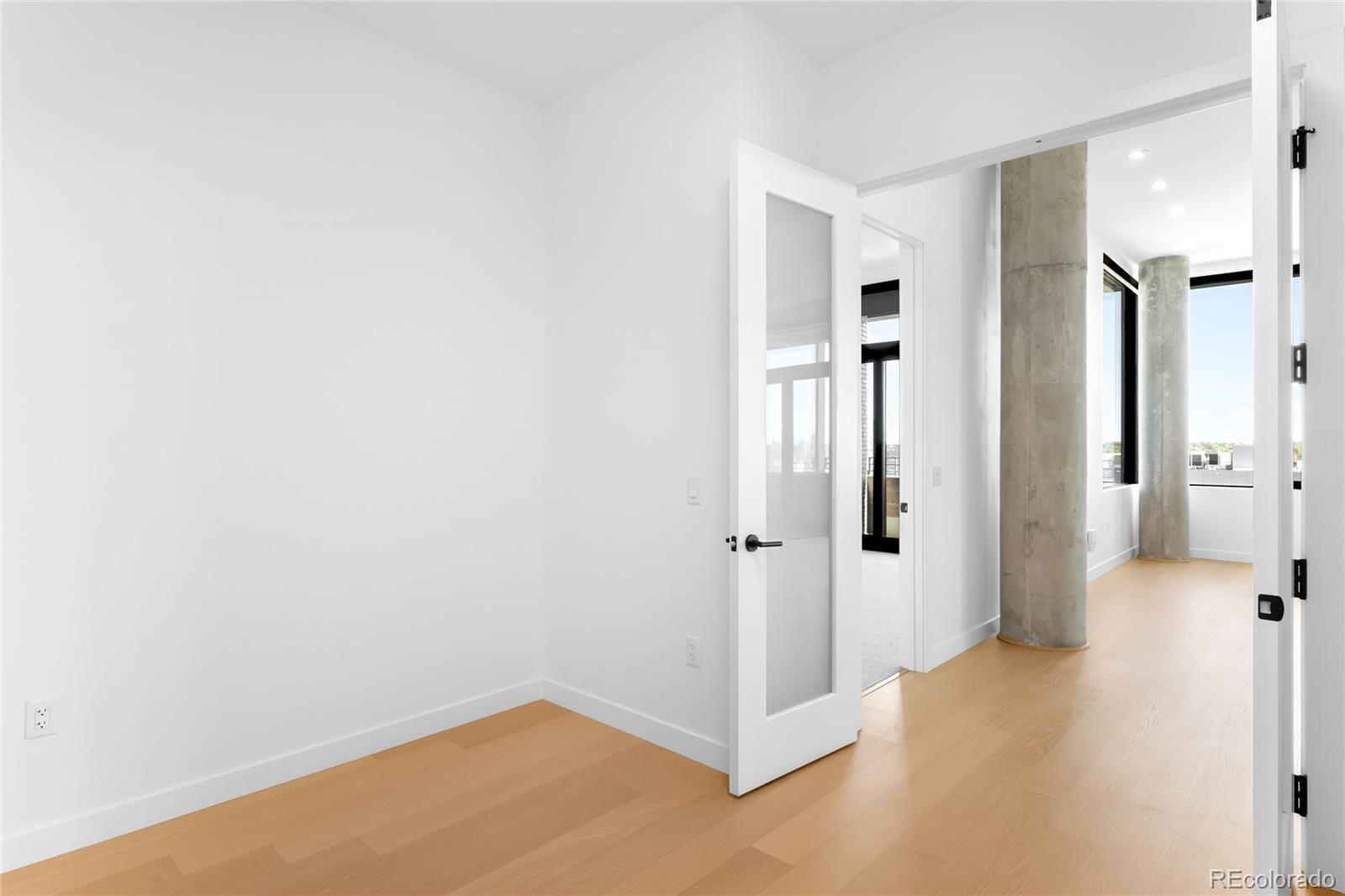 3520 Chestnut Place, Unit 1206 Denver, CO 80216 - Photo 14 of 41 a view of a hallway with wooden floor