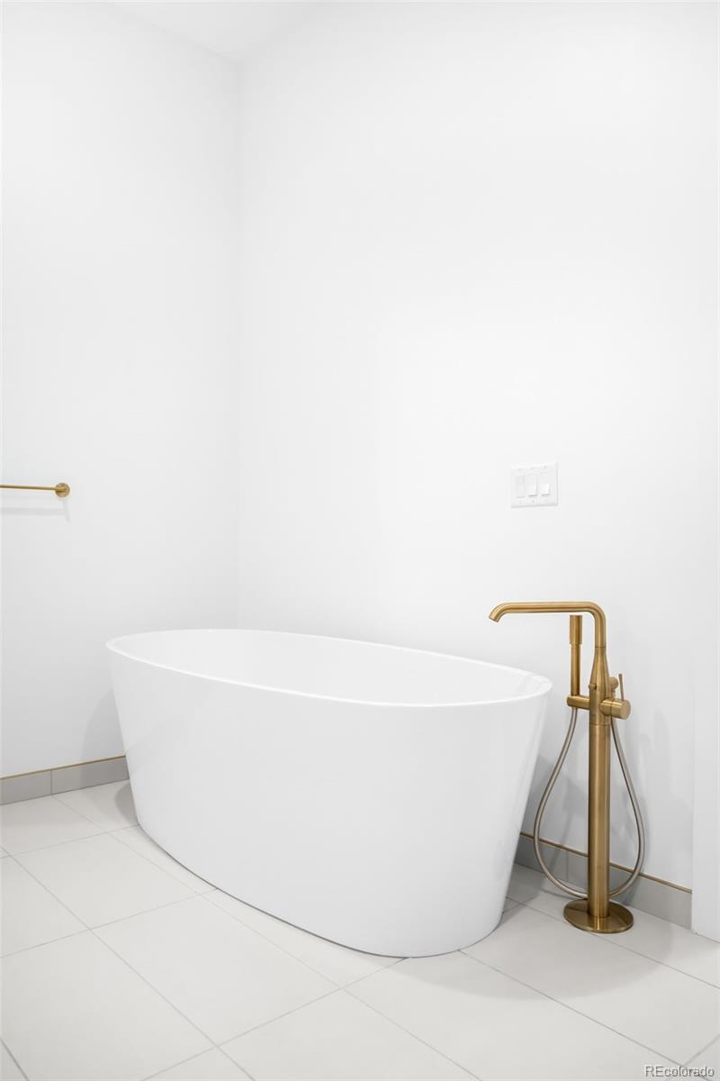 3520 Chestnut Place, Unit 1206 Denver, CO 80216 - Photo 20 of 41 a white tub sitting next to a white wall
