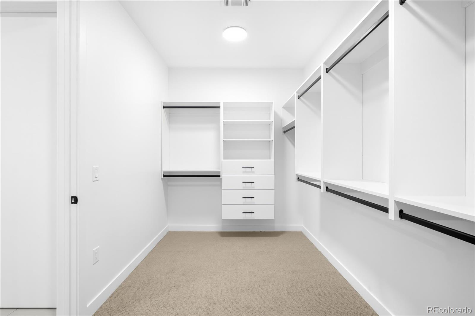 3520 Chestnut Place, Unit 1206 Denver, CO 80216 - Photo 21 of 41 a view of walk in closet with empty racks