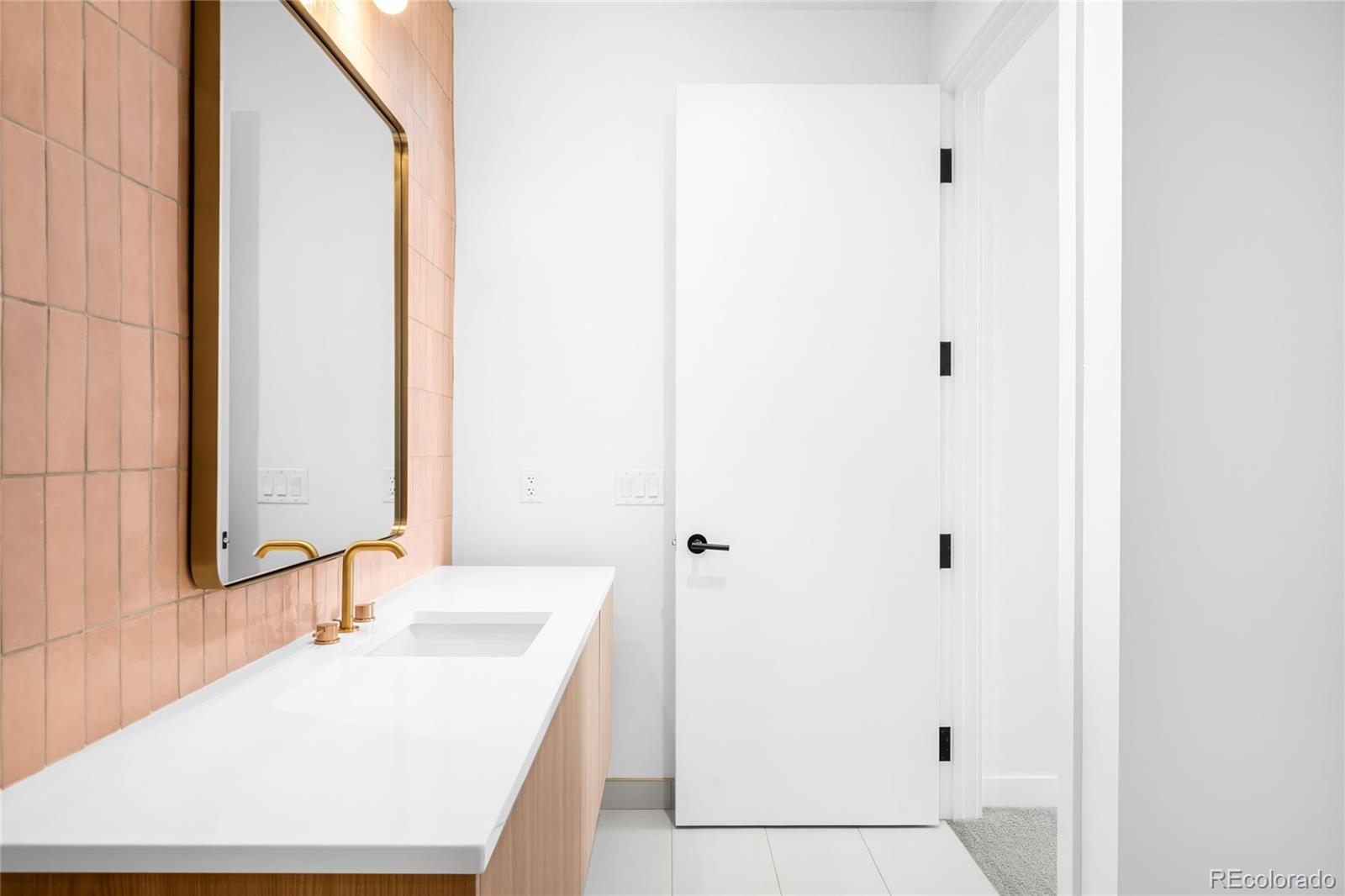 3520 Chestnut Place, Unit 1206 Denver, CO 80216 - Photo 26 of 41 a bathroom with a sink and a mirror