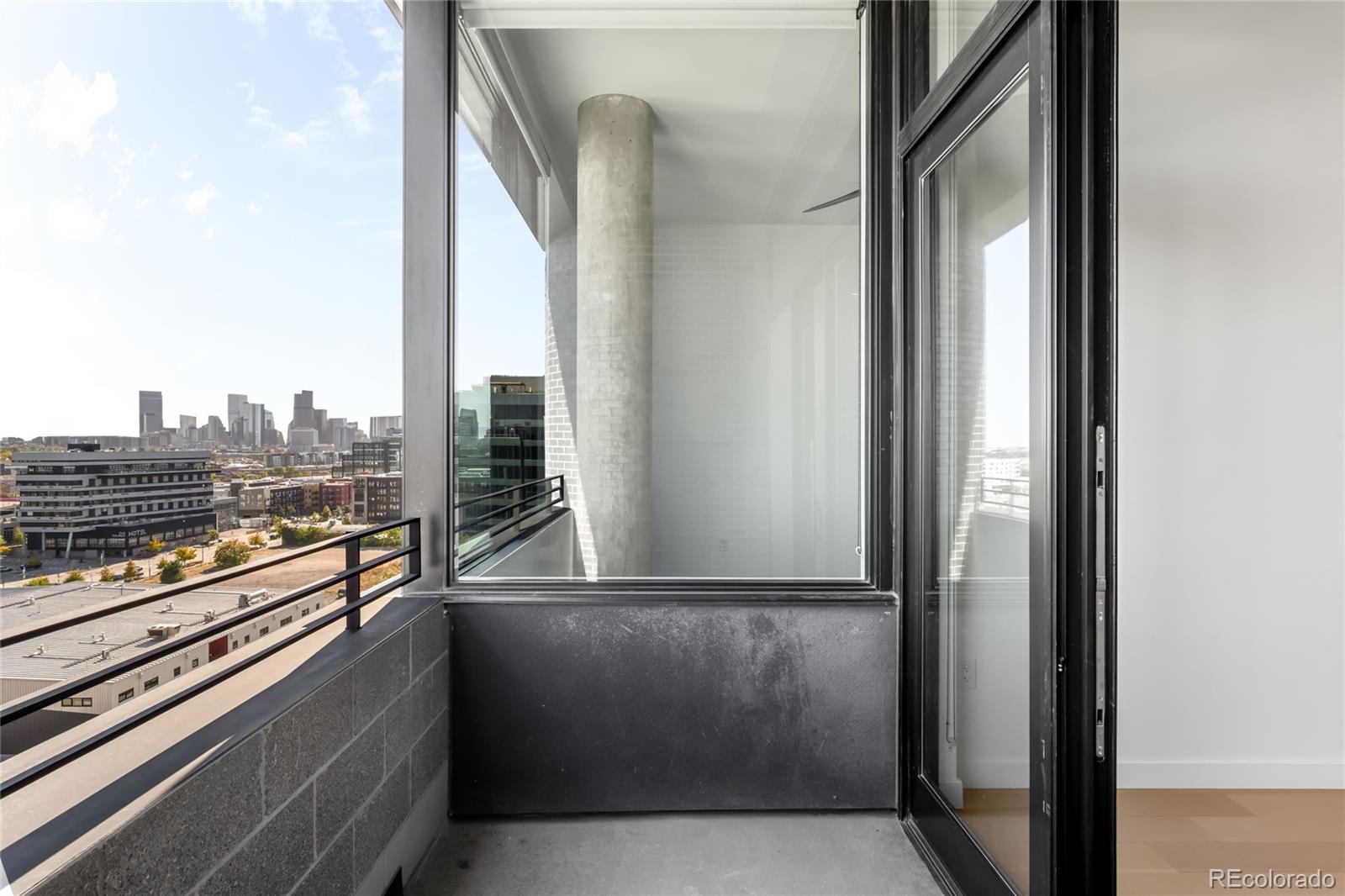 3520 Chestnut Place, Unit 1206 Denver, CO 80216 - Photo 29 of 41 a view of balcony with furniture and city view