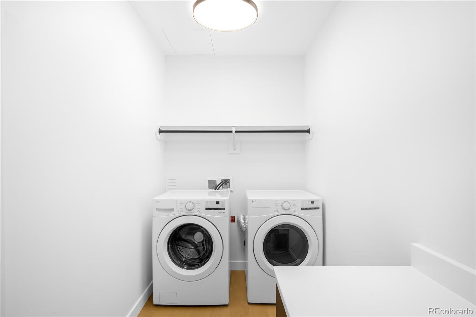 3520 Chestnut Place, Unit 1206 Denver, CO 80216 - Photo 31 of 41 a utility room with dryer and washer