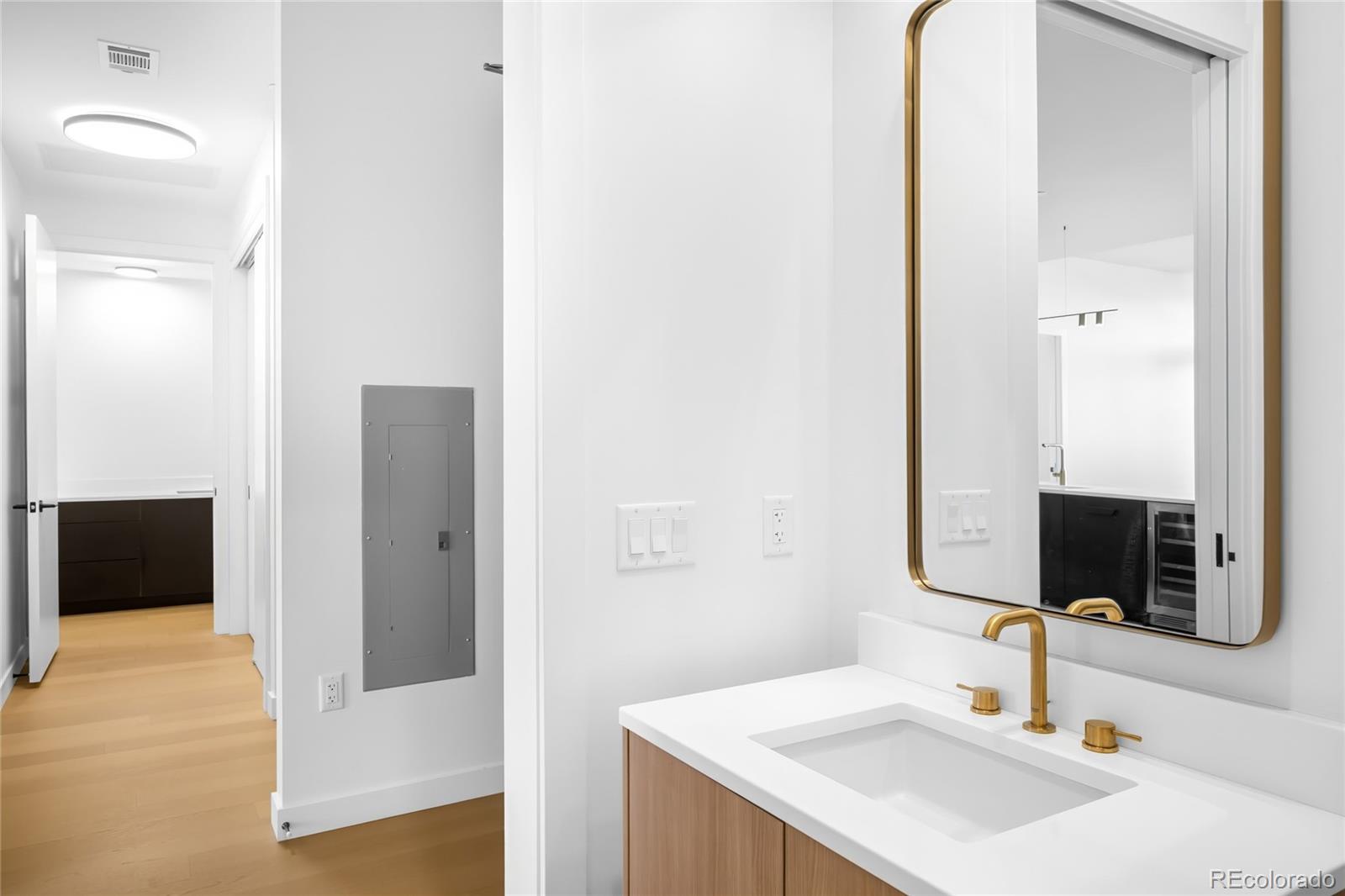 3520 Chestnut Place, Unit 1206 Denver, CO 80216 - Photo 32 of 41 a bathroom with a sink and a mirror