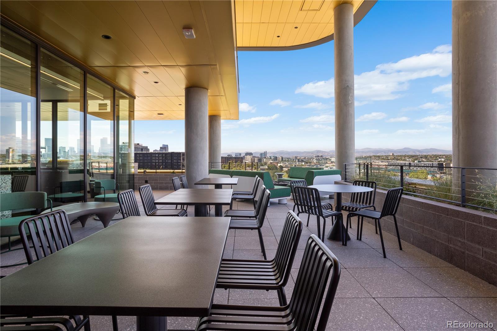3520 Chestnut Place, Unit 1206 Denver, CO 80216 - Photo 35 of 41 a view of a city from a dining room with furniture