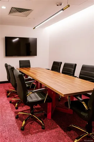 view of a hallway with wooden floor and wall paintings