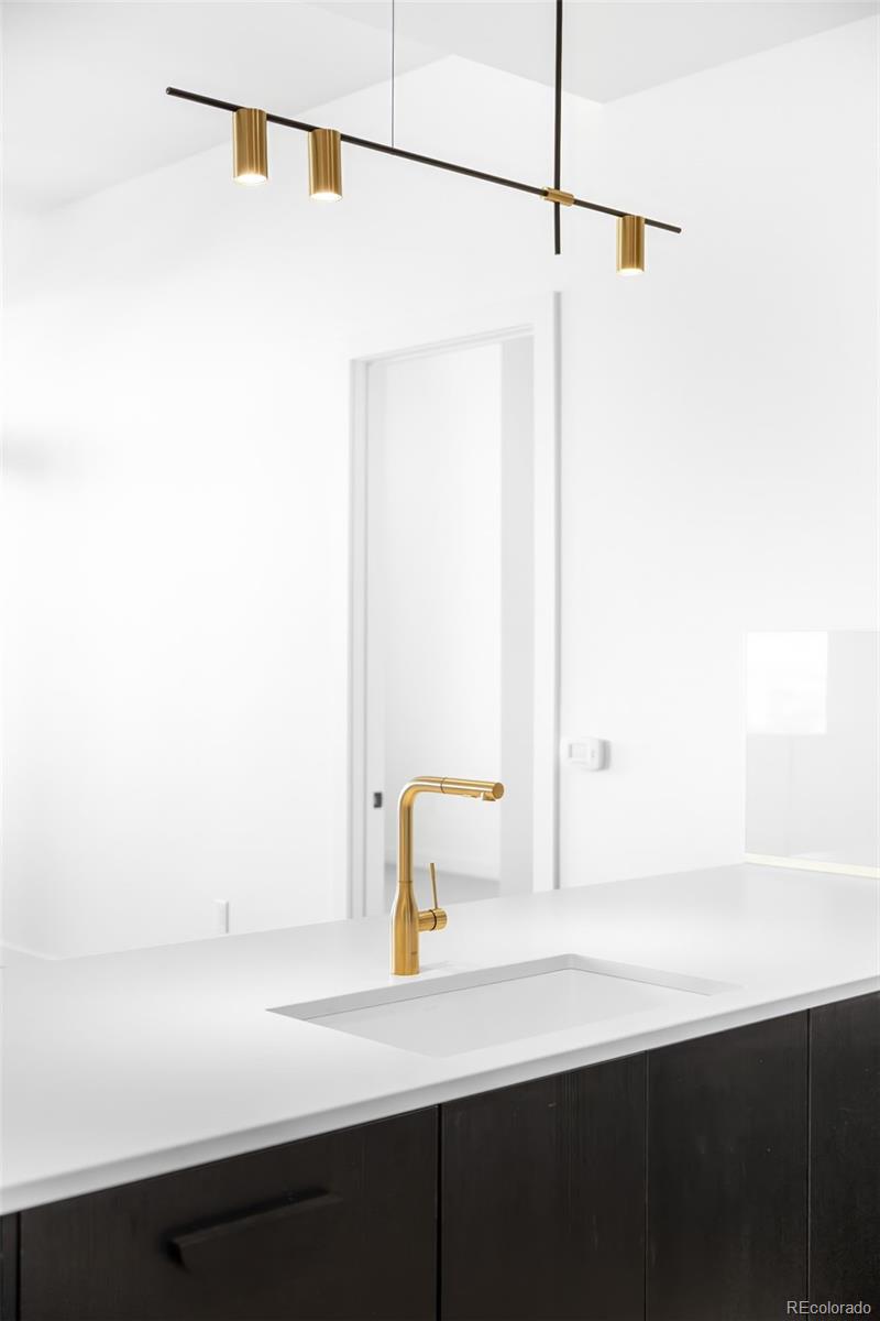 3520 Chestnut Place, Unit 1206 Denver, CO 80216 - Photo 8 of 41 a bathroom with a sink and a mirror