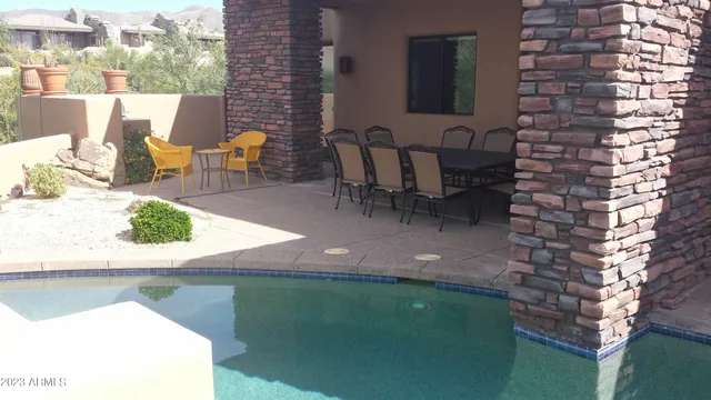 a view of a patio with table and chairs and potted plants