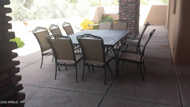 a view of a dining table and chairs in the patio