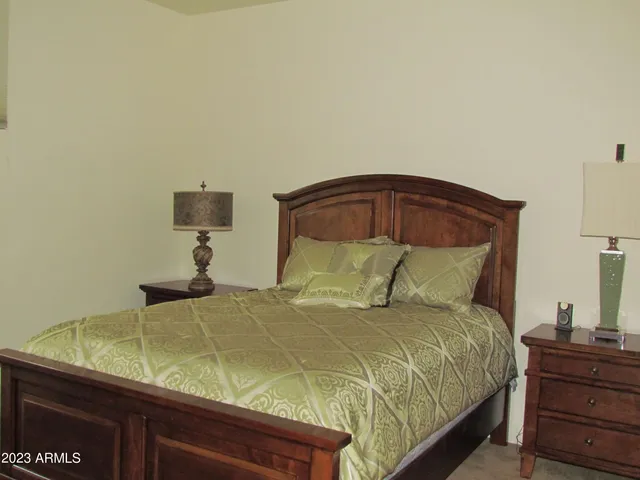 a bedroom with a bed and a night stand