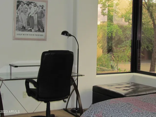 a bed sitting in a bedroom next to a lamp