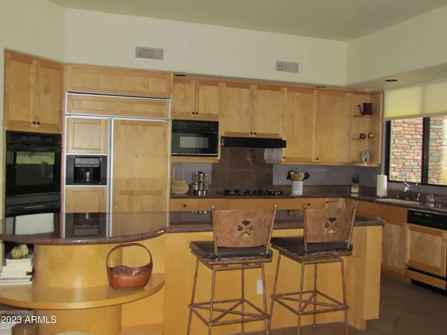 a kitchen with stainless steel appliances a sink and a refrigerator