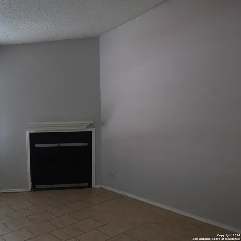 an empty room with closet and windows