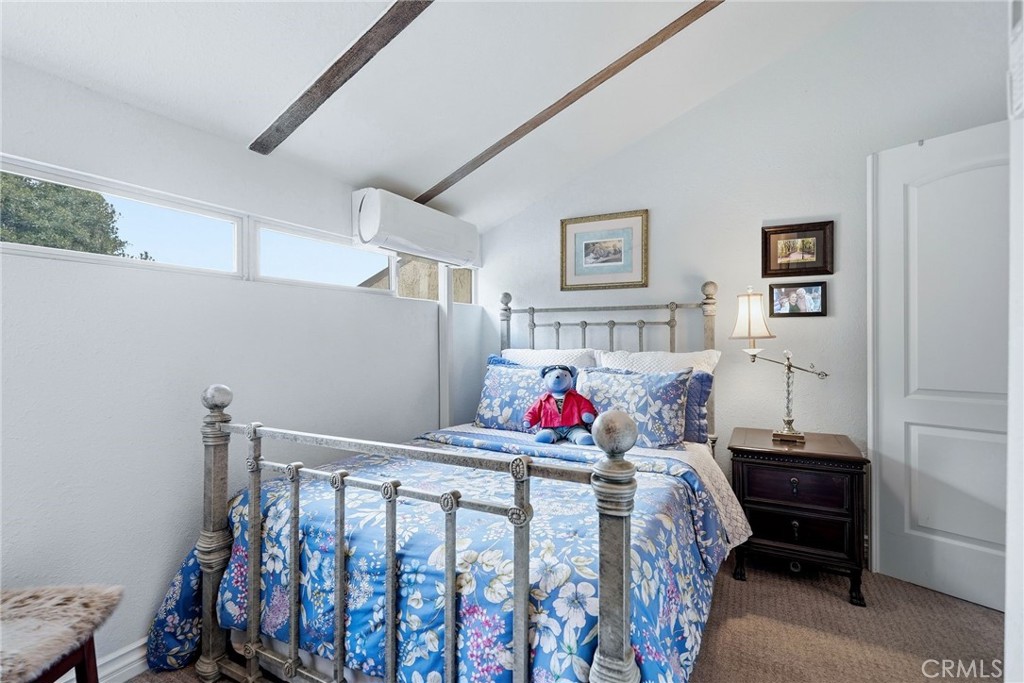 7890 East Spring Street, Unit 2L Long Beach, CA 90815 - Photo 30 of 47 a bedroom with two beds and wooden floor