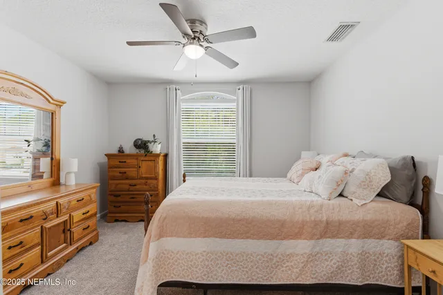 a bedroom with a large bed and a dresser