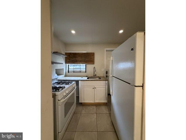 1609 Lemmon Street Baltimore, MD 21223 - Photo 4 of 16 a kitchen with a refrigerator and a stove