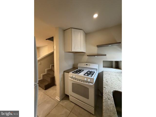 1609 Lemmon Street Baltimore, MD 21223 - Photo 5 of 16 a kitchen with stainless steel appliances granite countertop a stove a sink and a microwave