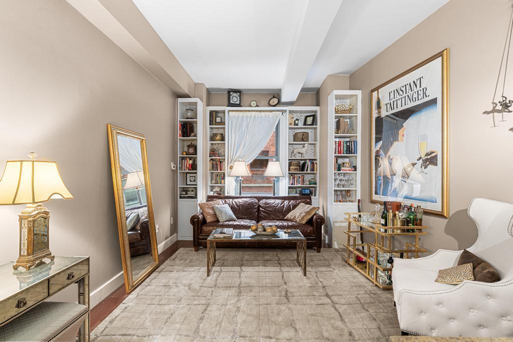 80 John Street, Unit 2A Manhattan, NY 10038 - Photo 3 of 10 a living room with furniture and a flat screen tv
