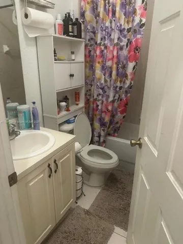 a bathroom with a sink toilet and mirror