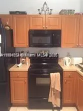 a kitchen with granite countertop a stove and a sink