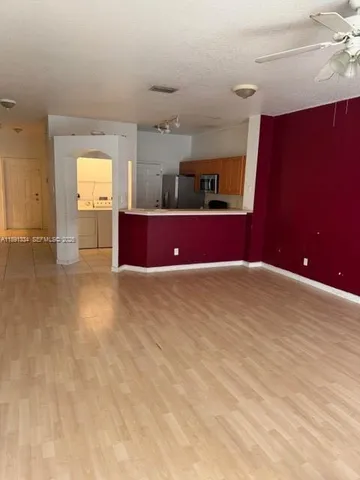 a kitchen with a refrigerator and a stove