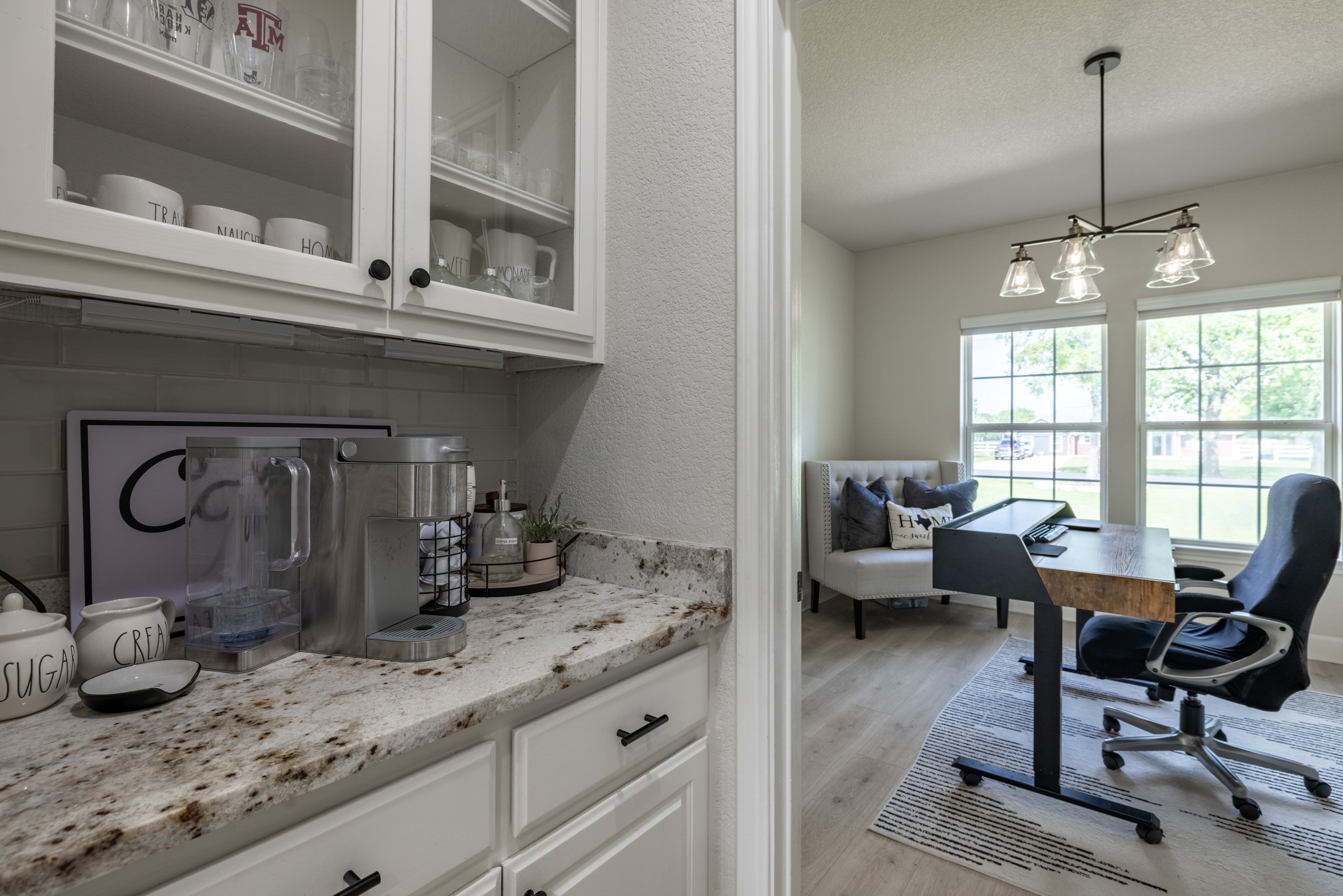 108 Kyle Lane Georgetown, TX 78633 - Photo 19 of 26 White shaker cabinetry with glass-front upper cabinets, granite-finish countertop, and subway tile backsplash