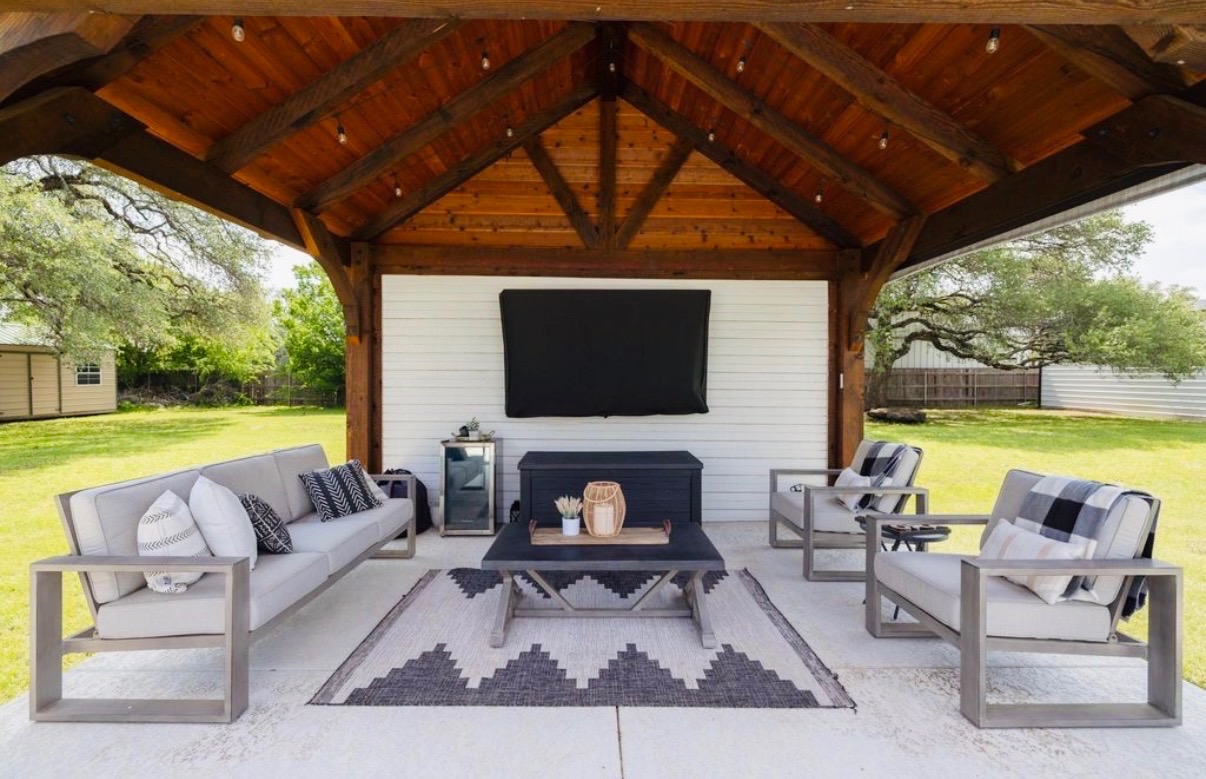 108 Kyle Lane Georgetown, TX 78633 - Photo 21 of 26 Expansive outdoor living area featuring a vaulted wood-beam ceiling with integrated lighting, a concrete patio, and a white paneled wall