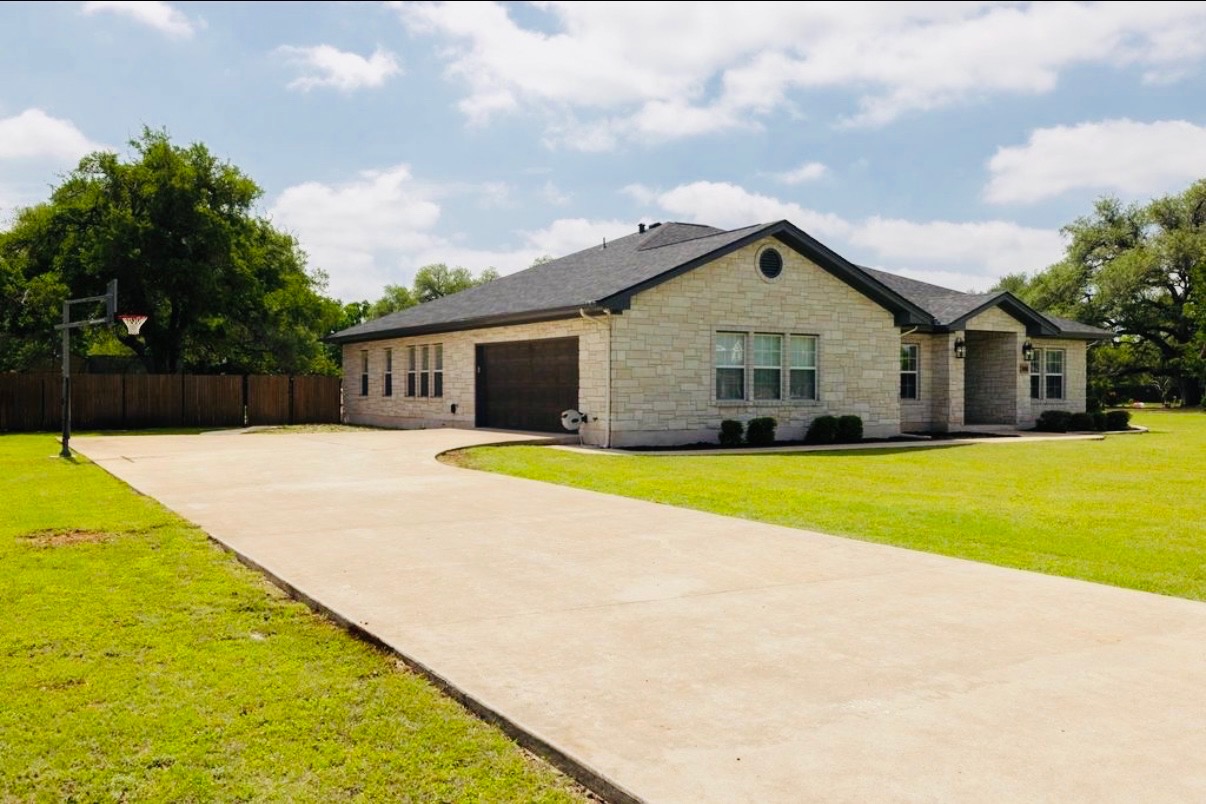 108 Kyle Lane Georgetown, TX 78633 - Photo 24 of 26 Stone veneer exterior with dark shingle roofing