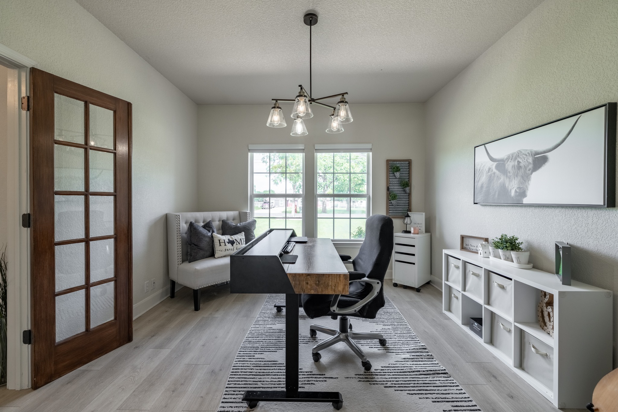 108 Kyle Lane Georgetown, TX 78633 - Photo 4 of 26 Spacious room featuring wood-finish flooring, a contemporary chandelier, and French doors with frosted glass panels